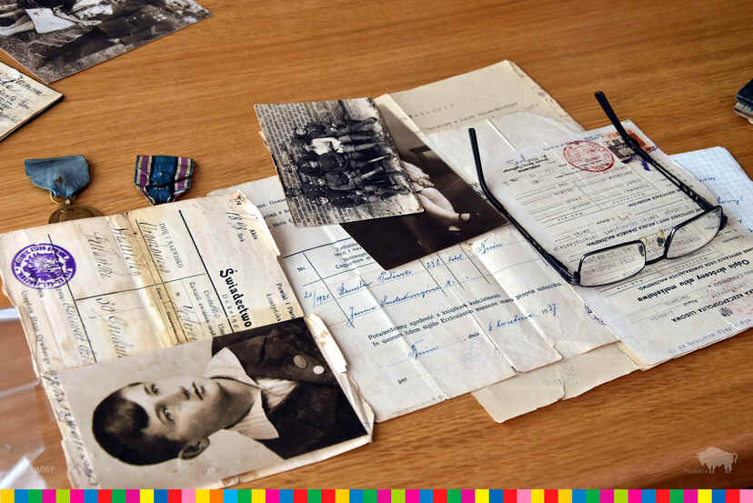 Stare dokumenty i zdjęcia leżące na stole.