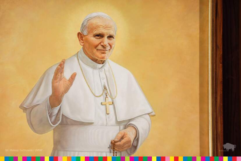 Fragment obrazu. Jan Paweł II na żółtym tle trzyma dłoń w geście błogosławieństwa.