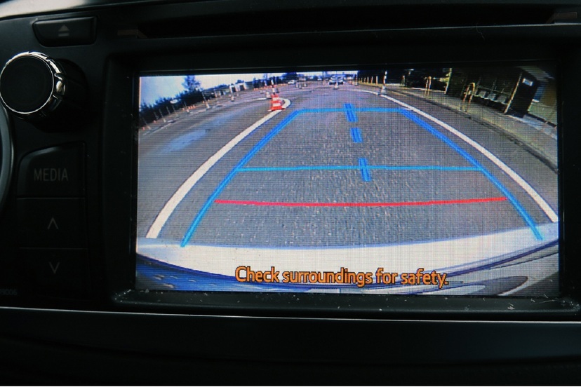 Widok na ekran w samochodzie, na którym widać drogę asfaltową