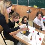 Cztery dziewczyny przeprowadzające eksperyment na lekcji chemii