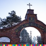 Brama cmentarza z wieżyczką zwieńczoną krzyżem