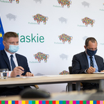 Dwaj mężczyźni siedzą za stołem - Marek Malinowski, Członek Zarządu Województwa Podlaskiego po lewej stronie,  Dominik Maślach, dyrektor Departamentu Zdrowia po prawej 