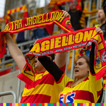 Kibice w strojach czerwono-żółtych trzymają szaliki klubu Jagiellonia
