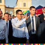 Premier Mateusz Morawiecki macha ręką do uczestników spotkania 