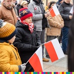 Dzieci trzymają w rękach biało-czerwone flagi